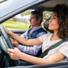 Young African American woman taking her driving test and looking very focused Young African American woman taking her driving test and looking very focused